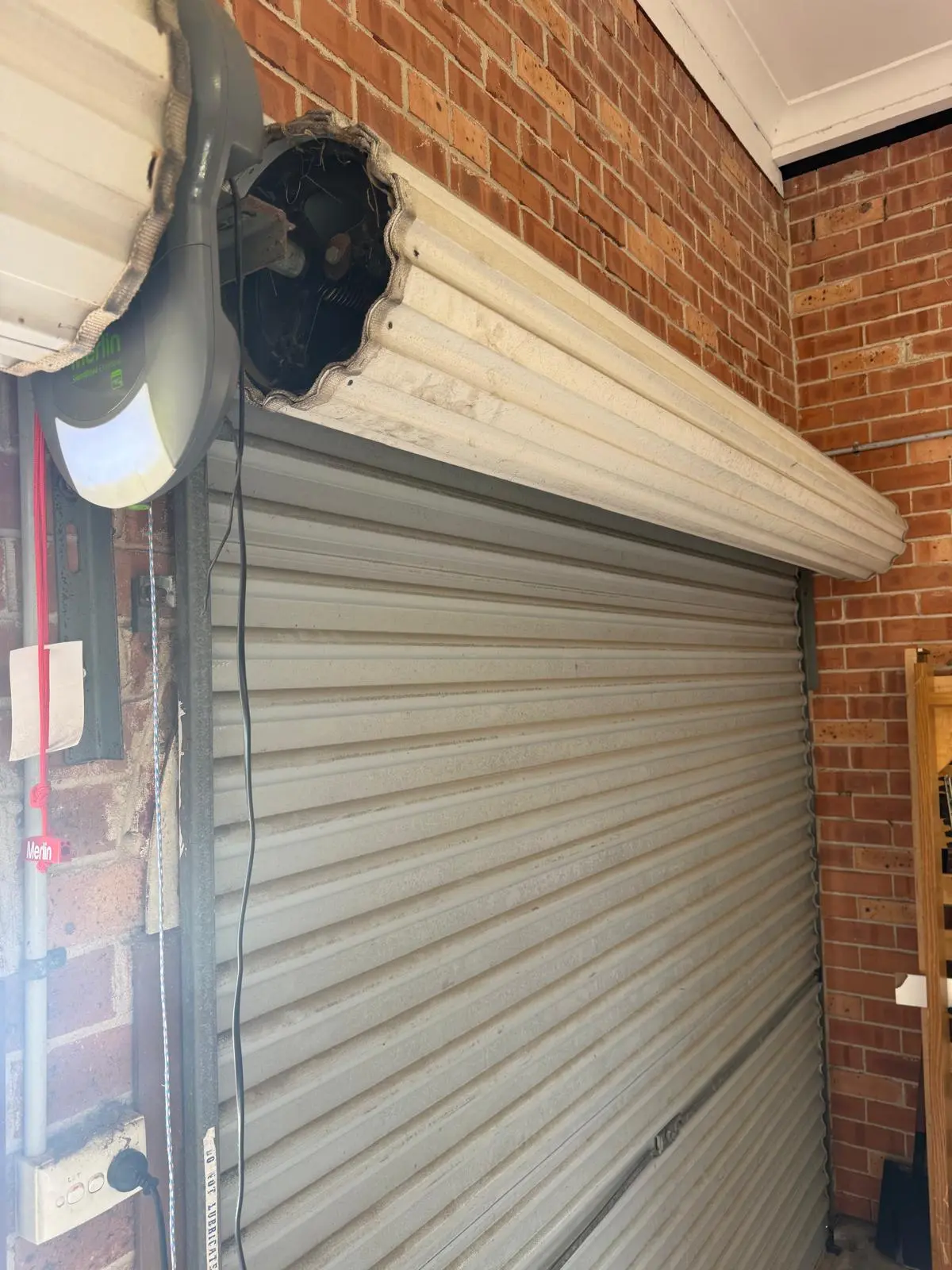 Damaged roller door motor housing and mechanical inspection